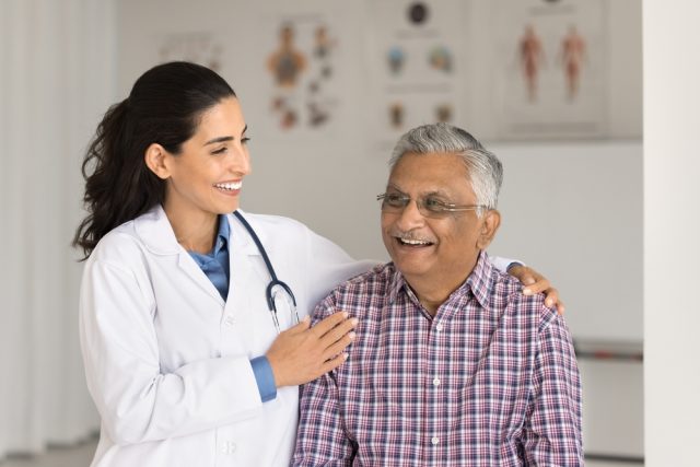 a doctor interacts with a senior male patient