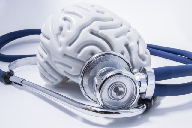 The figure of the human brain with a stethoscope around it