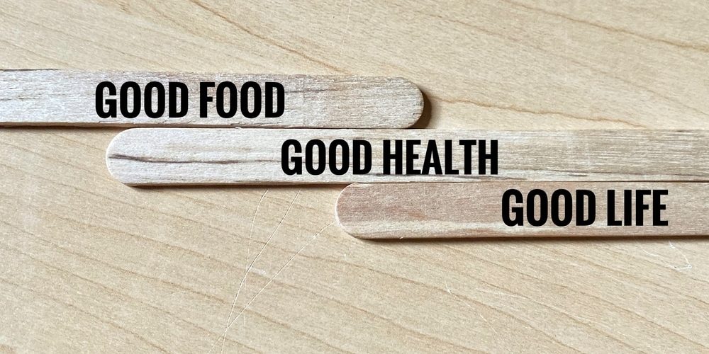 Wooden popsicle sticks with written phrase Good Food, Good Health, and Good Life.