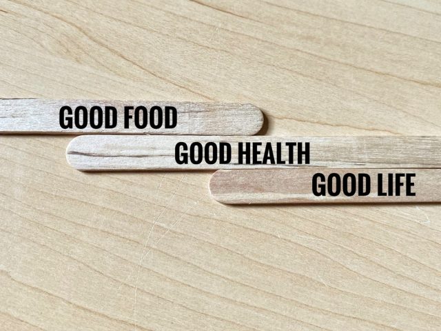 Wooden popsicle sticks with written phrase Good Food, Good Health, and Good Life.