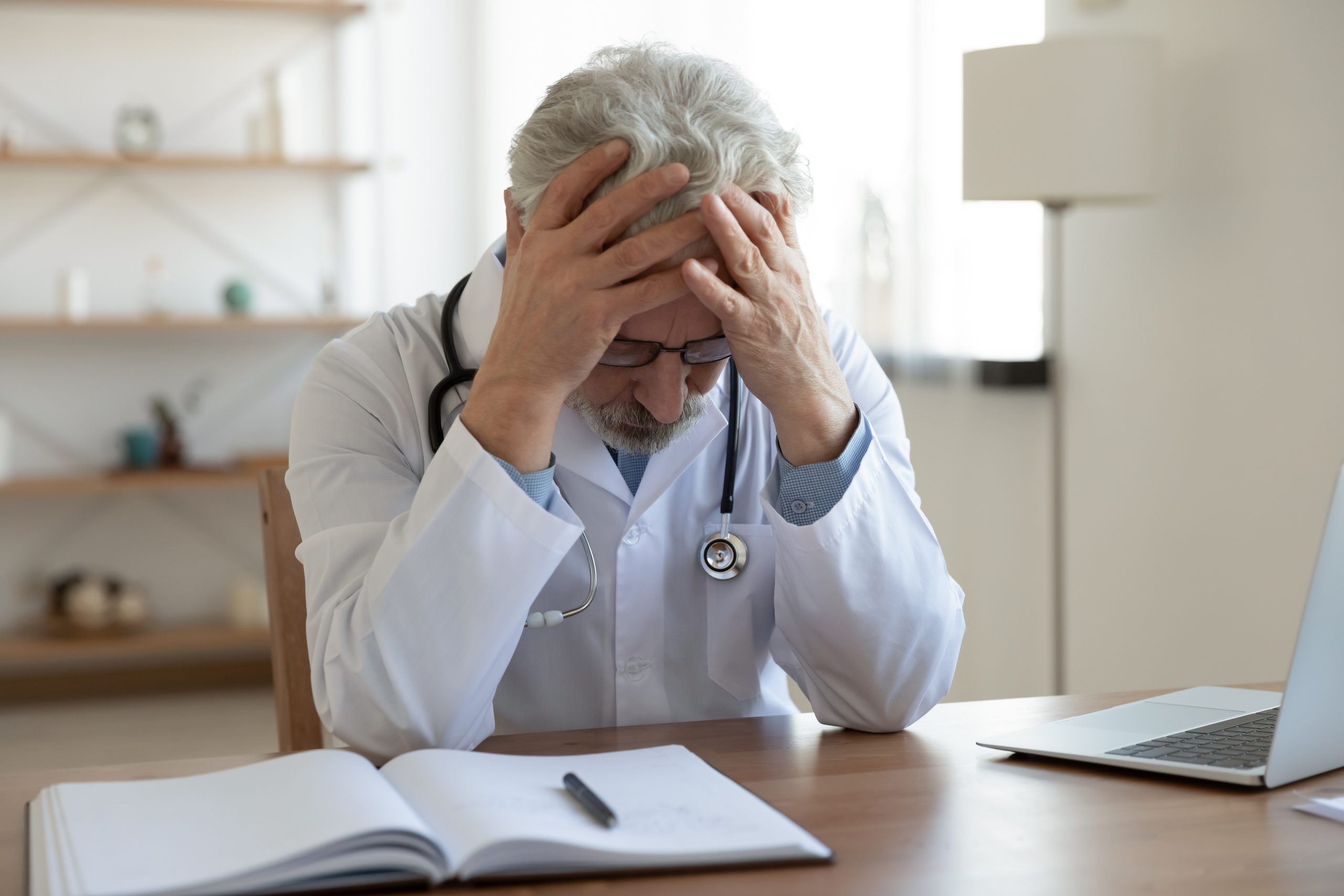 Frustrated doctor working on paperwork